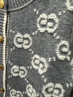 Dark green knit fabric with scattered GG monogram pattern