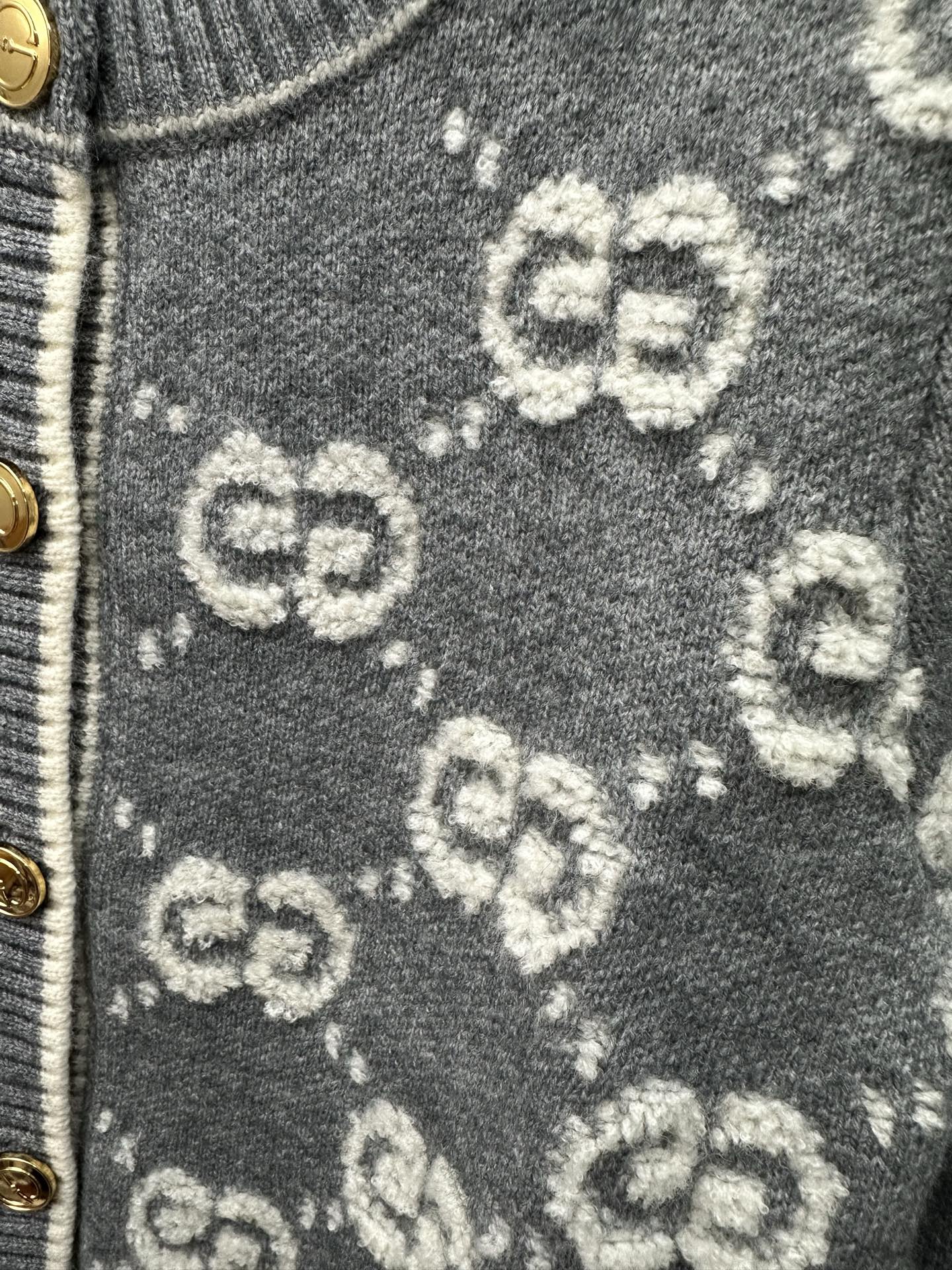 Dark green knit fabric with scattered GG monogram pattern