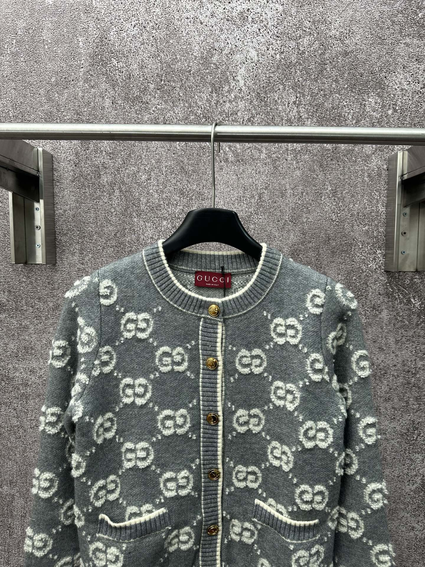 Gucci dark green knit cardigan with GG logo pattern, round ribbed collar, gold button placket.