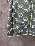 Dark green GG monogram cardigan detail with stitched pocket and ribbed hem