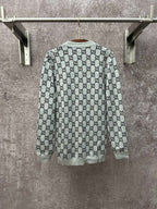 Gucci long-sleeve crewneck top with light gray base and black GG monogram print