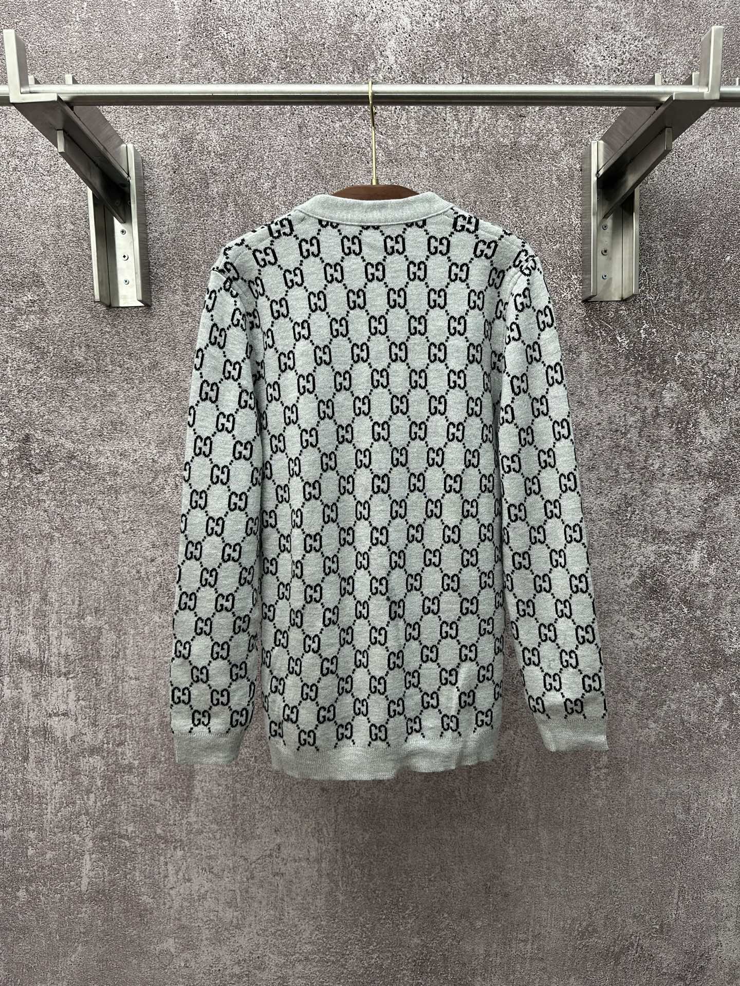 Gucci long-sleeve crewneck top with light gray base and black GG monogram print
