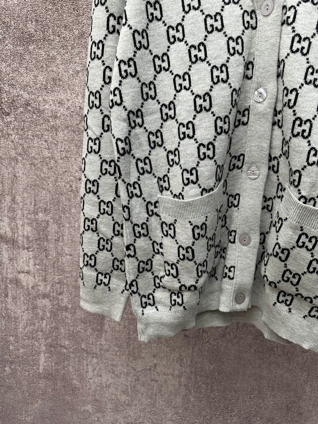Gucci long-sleeve top with light gray body and black GG monogram repeat pattern