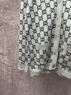 Gucci long-sleeve top with light gray body and black GG monogram repeat pattern