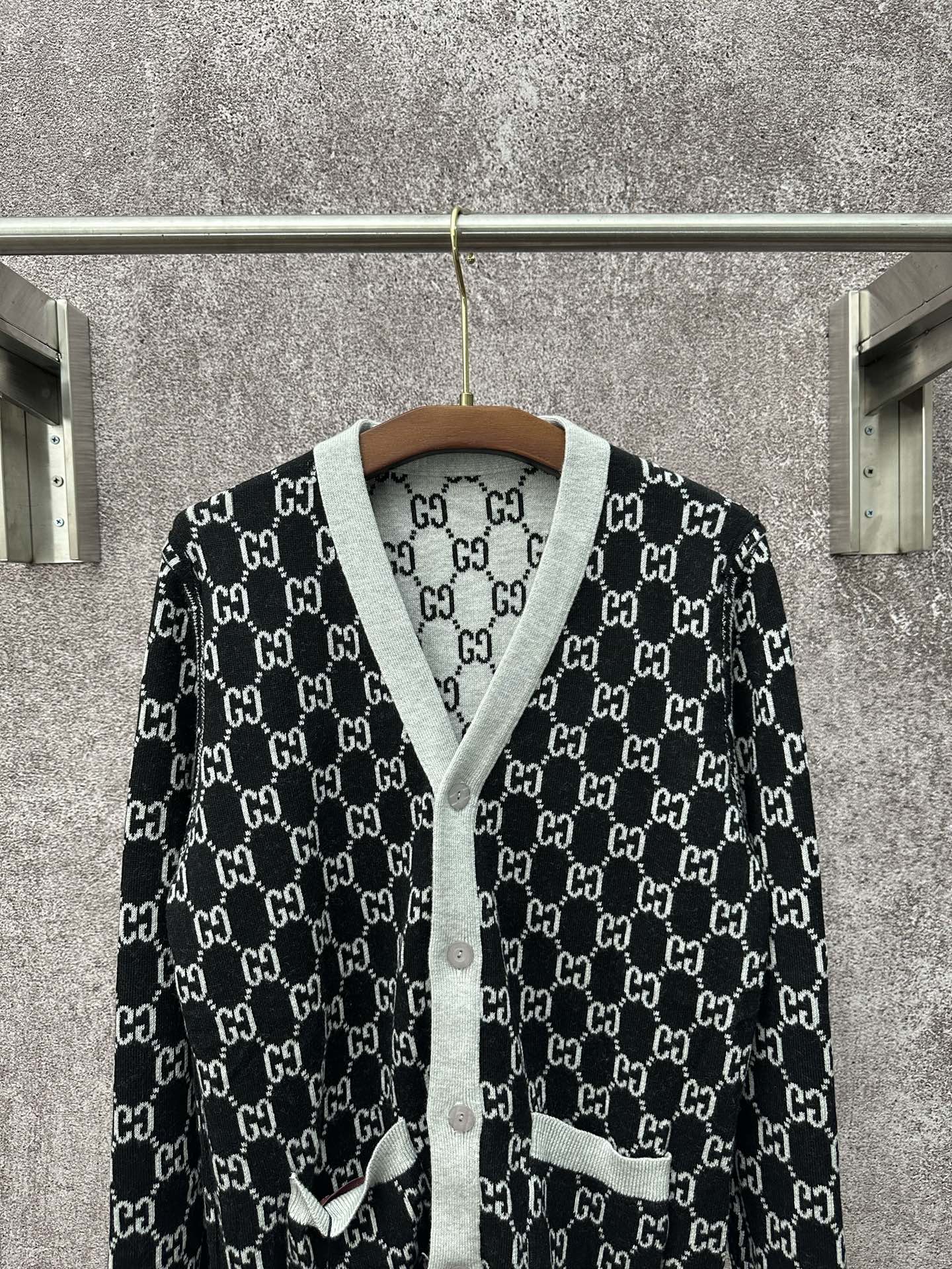Gucci long-sleeve sweater on hanger, black GG monogram pattern with gray trim