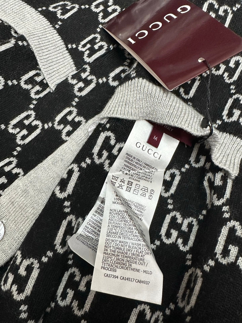 Gucci knit sweater neckline and label, black GG pattern with gray ribbing