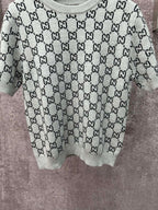 Light gray knit T-shirt with black GG logo pattern and ribbed crew collar