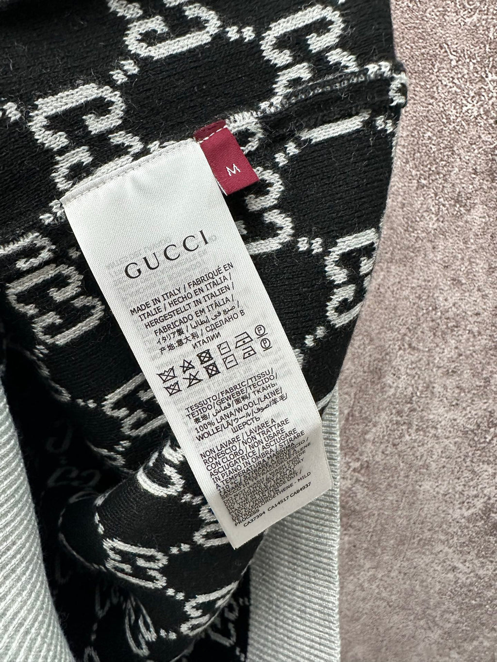 Gucci size label on black-and-white knit fabric with patterned weave