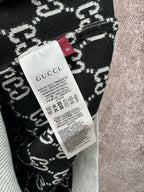 Gucci size label on black-and-white knit fabric with patterned weave