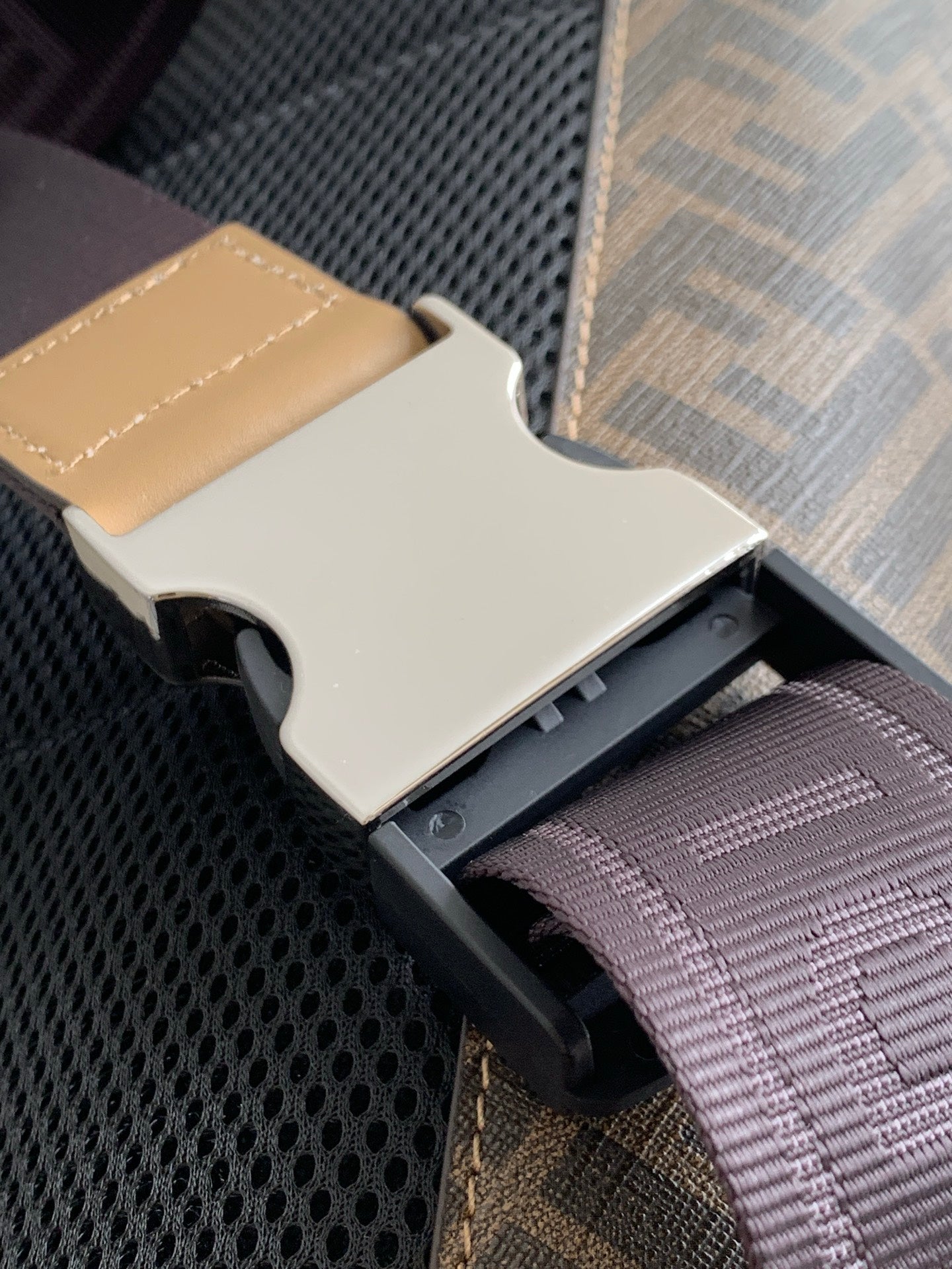 Fendi bag logo strap hardware with cutout detail and textured interior panel
