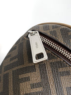 Fendi bag detail: silver zipper pull on FF monogram fabric with luggage tag