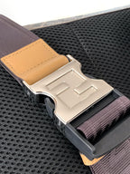 Fendi bag strap connector with engraved logo hardware and beige tab