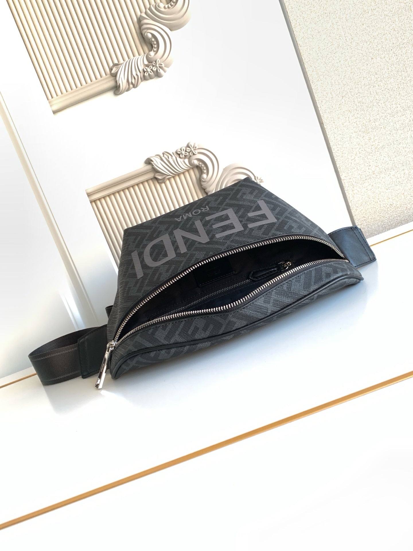 Fendi crossbody bag with dark monogram fabric, dual zippers, and shoulder strap