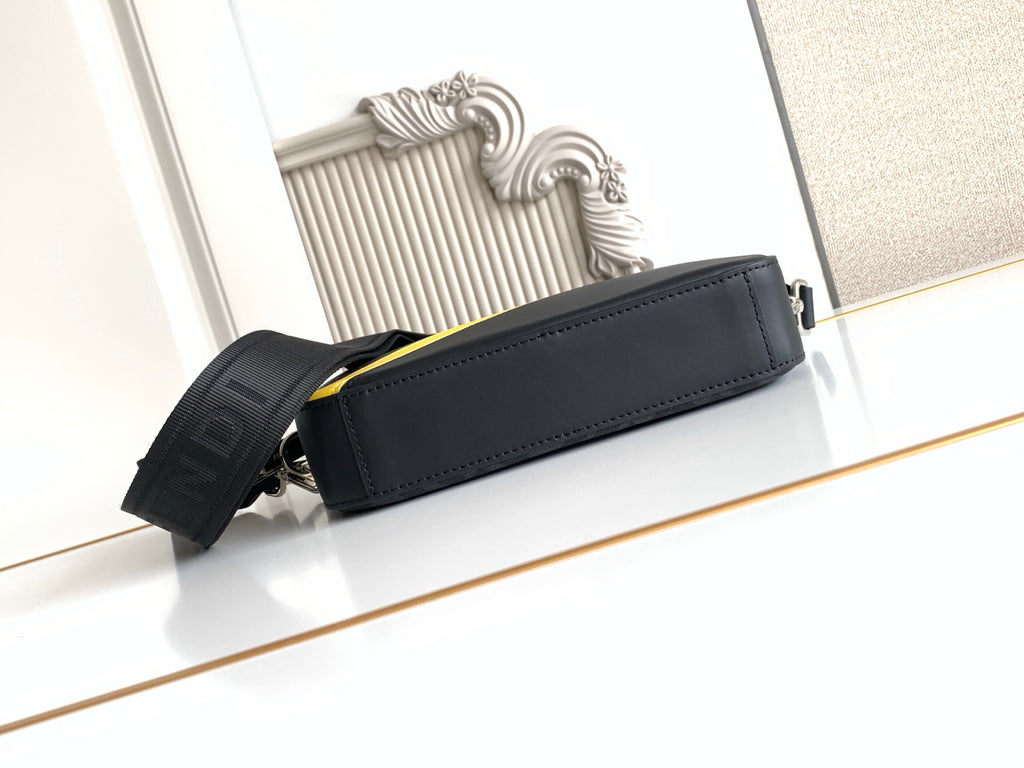 Fendi crossbody bag with yellow piping, structured top, and adjustable shoulder strap