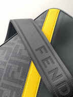 Fendi bag close-up: striped fabric panel with yellow leather trim and stitched edging
