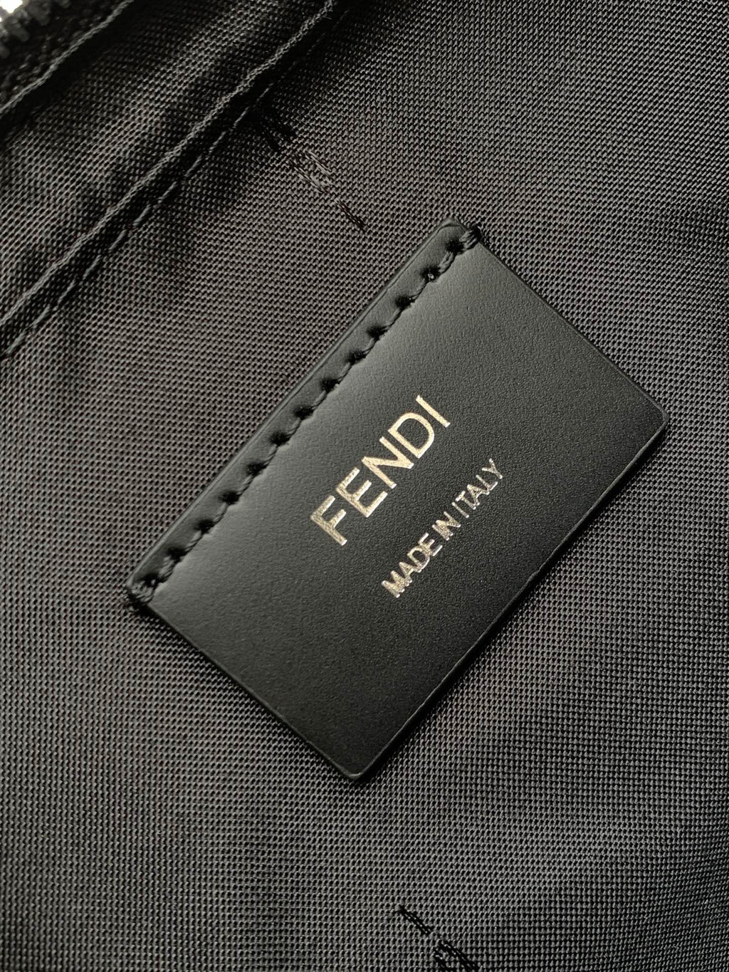 Fendi bag interior label reading "FENDI" and "MADE IN ITALY"