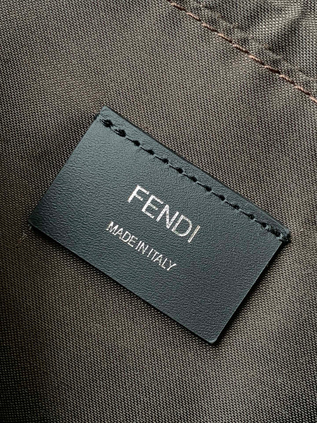Fendi label on dark bag interior with MADE IN ITALY text