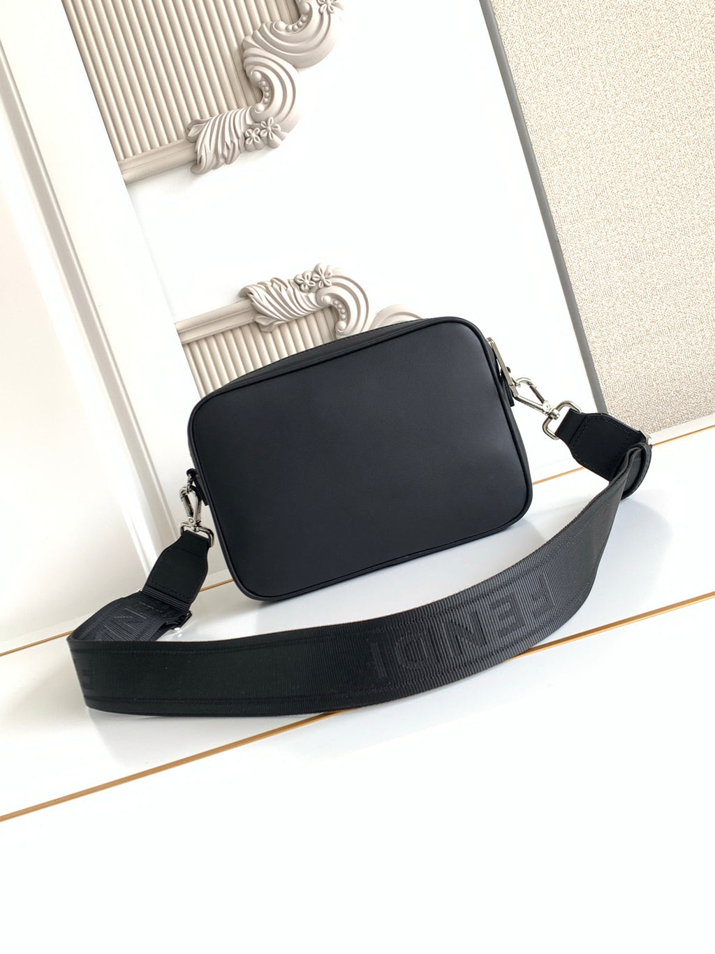 Fendi black crossbody bag with wide web strap and top zip opening