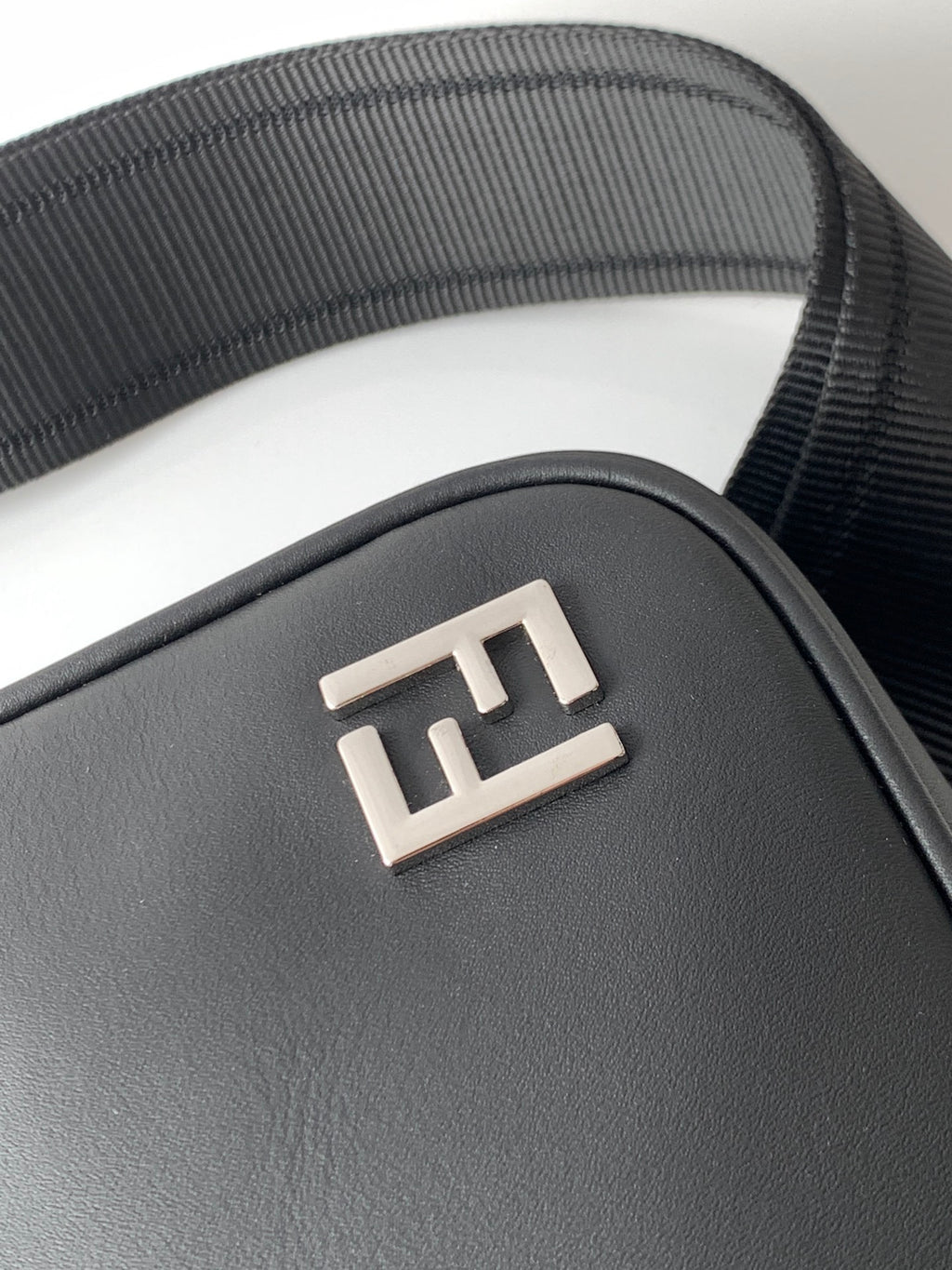 Fendi black bag front with embossed FF logo plate