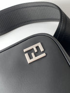 Fendi black bag front with embossed FF logo plate