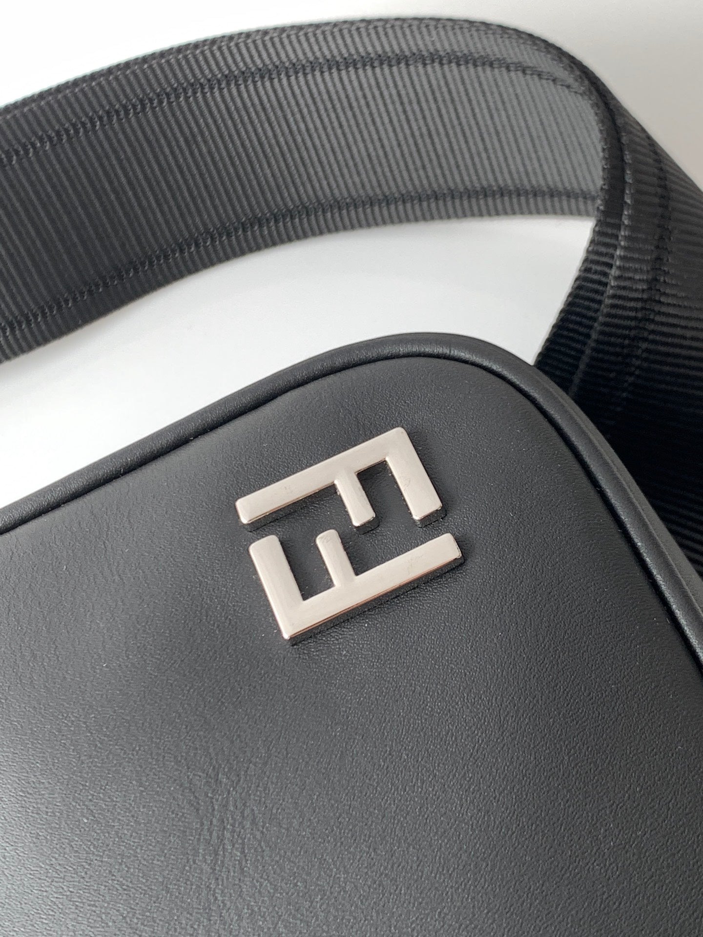Fendi black bag front with embossed FF logo plate