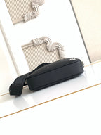Fendi black long-strap bag lying on side, zip closure and silver rings