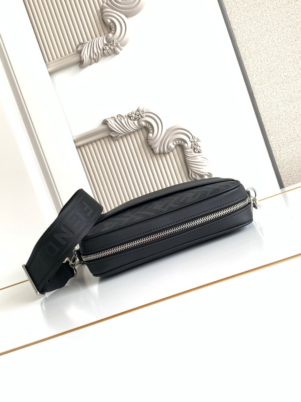 Fendi black mini crossbody bag with front zip and chain-strap hardware