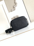 Fendi crossbody bag in dark textured leather with embossed FENDI logo and zip top.