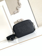 Fendi crossbody bag in dark textured leather with embossed FENDI logo and zip top.