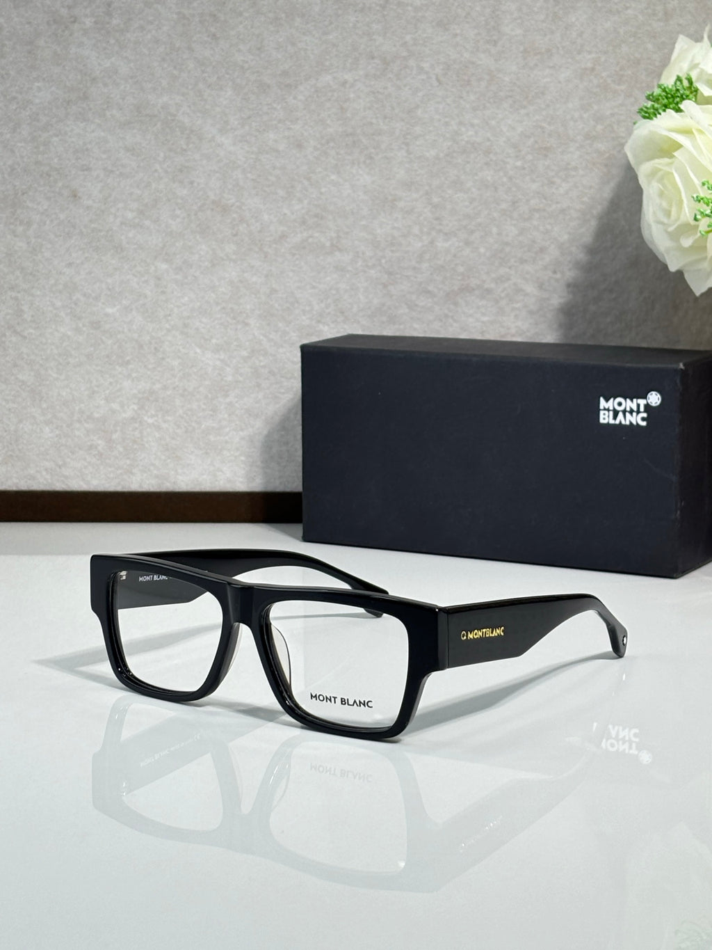 Black full-rim eyeglasses with rectangular frames and clear lenses, Montblanc branding