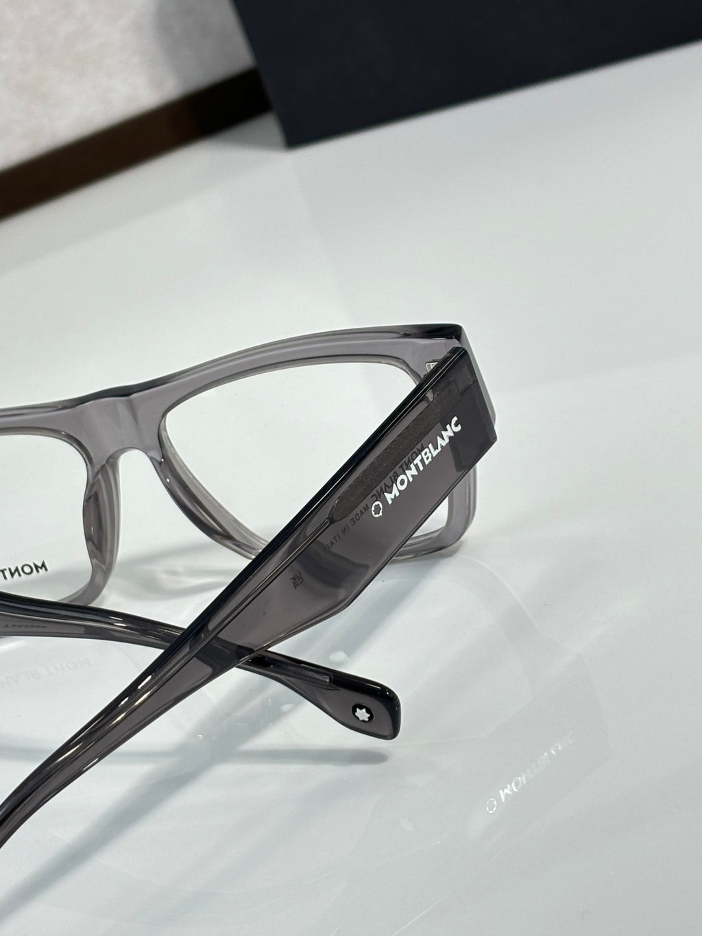 Close-up of black temple arm on eyeglasses with clear lens and Montblanc branding