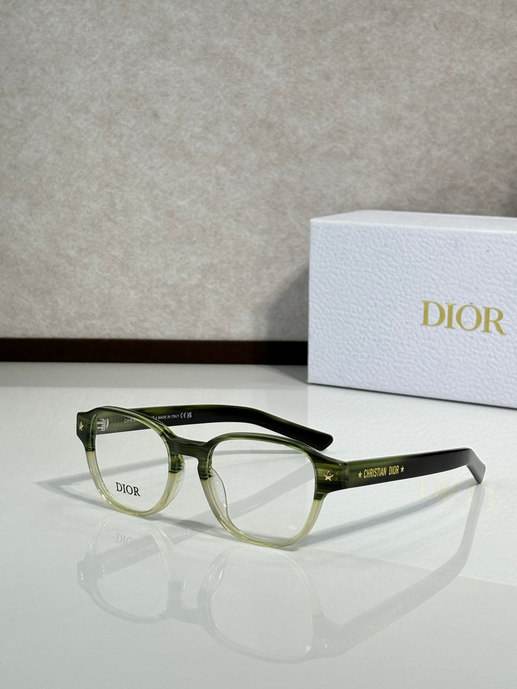 Dior eyeglasses with green full-rim frames and clear lenses, side view