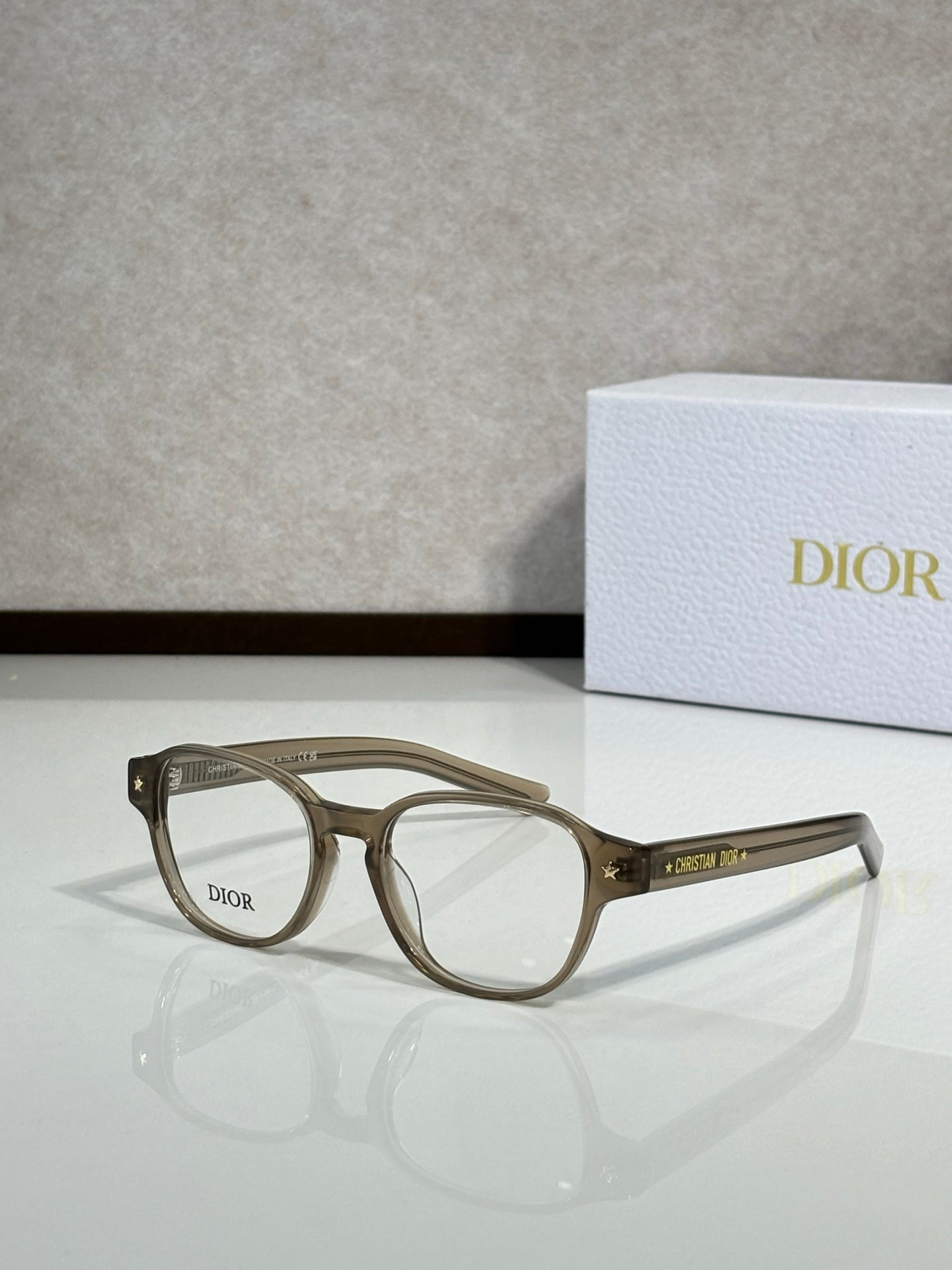 Dior eyeglasses with olive-brown full-rim frames and clear lenses, side view