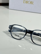 Dior eyeglasses with dark blue full-rim frames and clear lenses, close-up