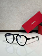 Prada eyeglasses with black round frames and clear lenses, side arms with logo.
