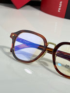 Prada eyeglasses with brown round frames and blue-tinted lens, logo on lens center.