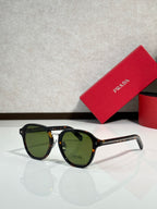 Prada tortoise round eyeglasses with green-tinted lenses and dark accents