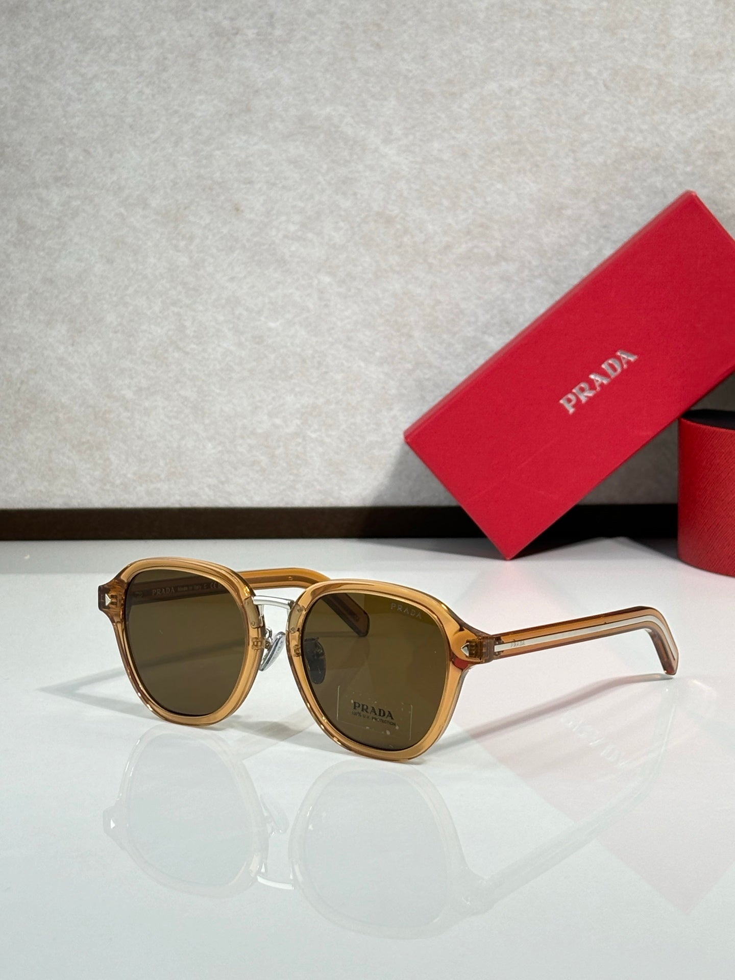 Prada brown round eyeglasses with gold-tone frame and dark tinted lenses
