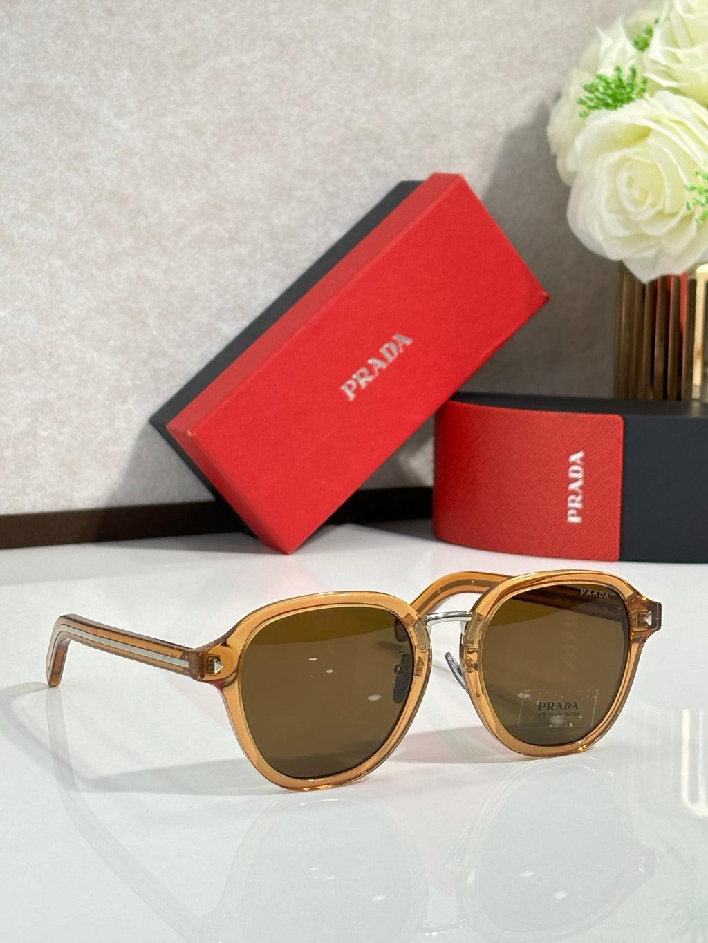 Prada gold round eyeglasses with brown lenses, with red case