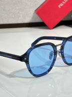 Prada blue round eyeglasses with navy frame and light blue tinted lenses
