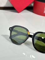 Prada black round eyeglasses with green-tinted lenses and side logo