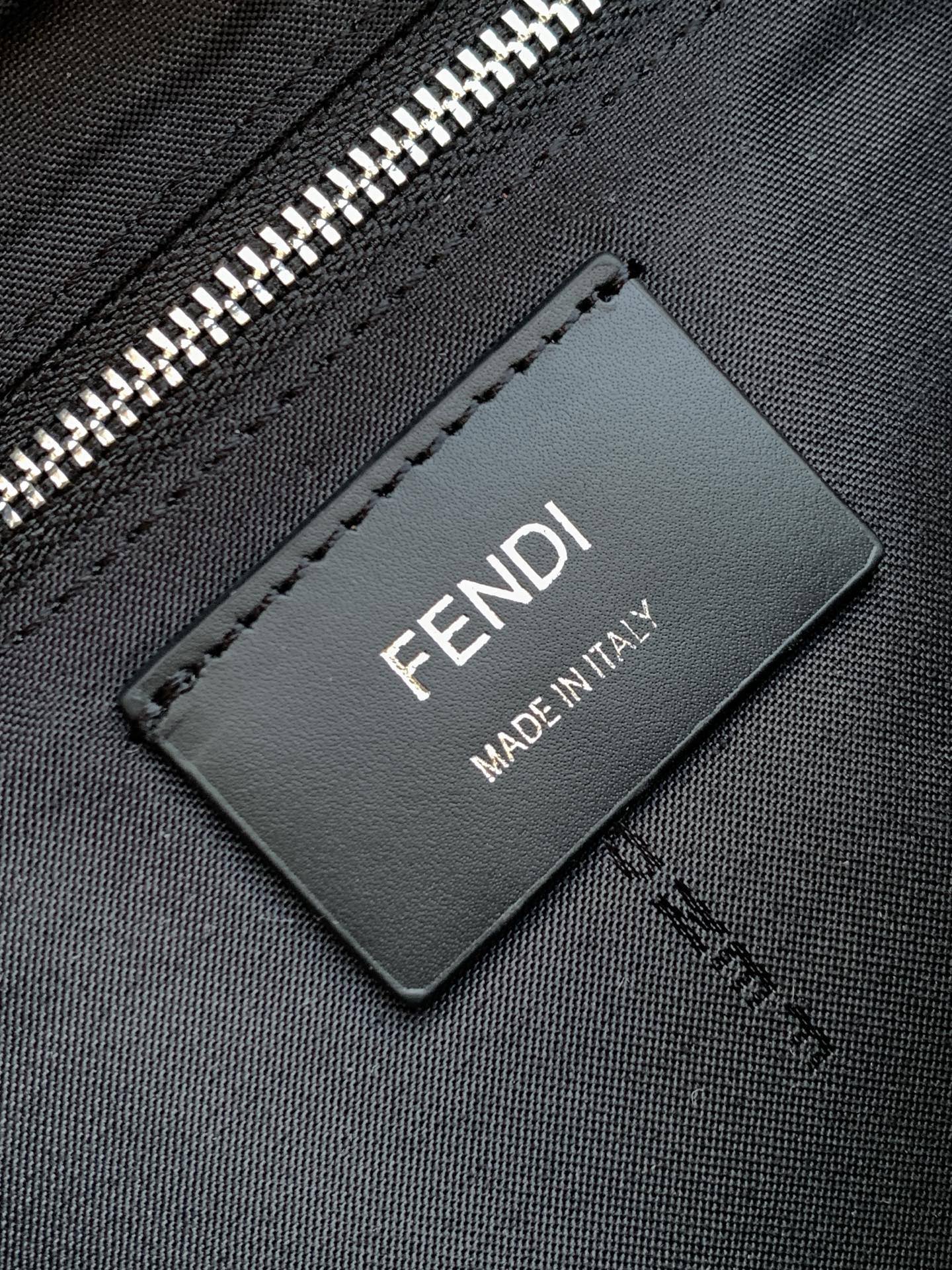Black Fendi Made in Italy leather label on zipper pouch