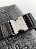 Black leather bag detail with silver-tone F buckle and embossed FENDI on surface