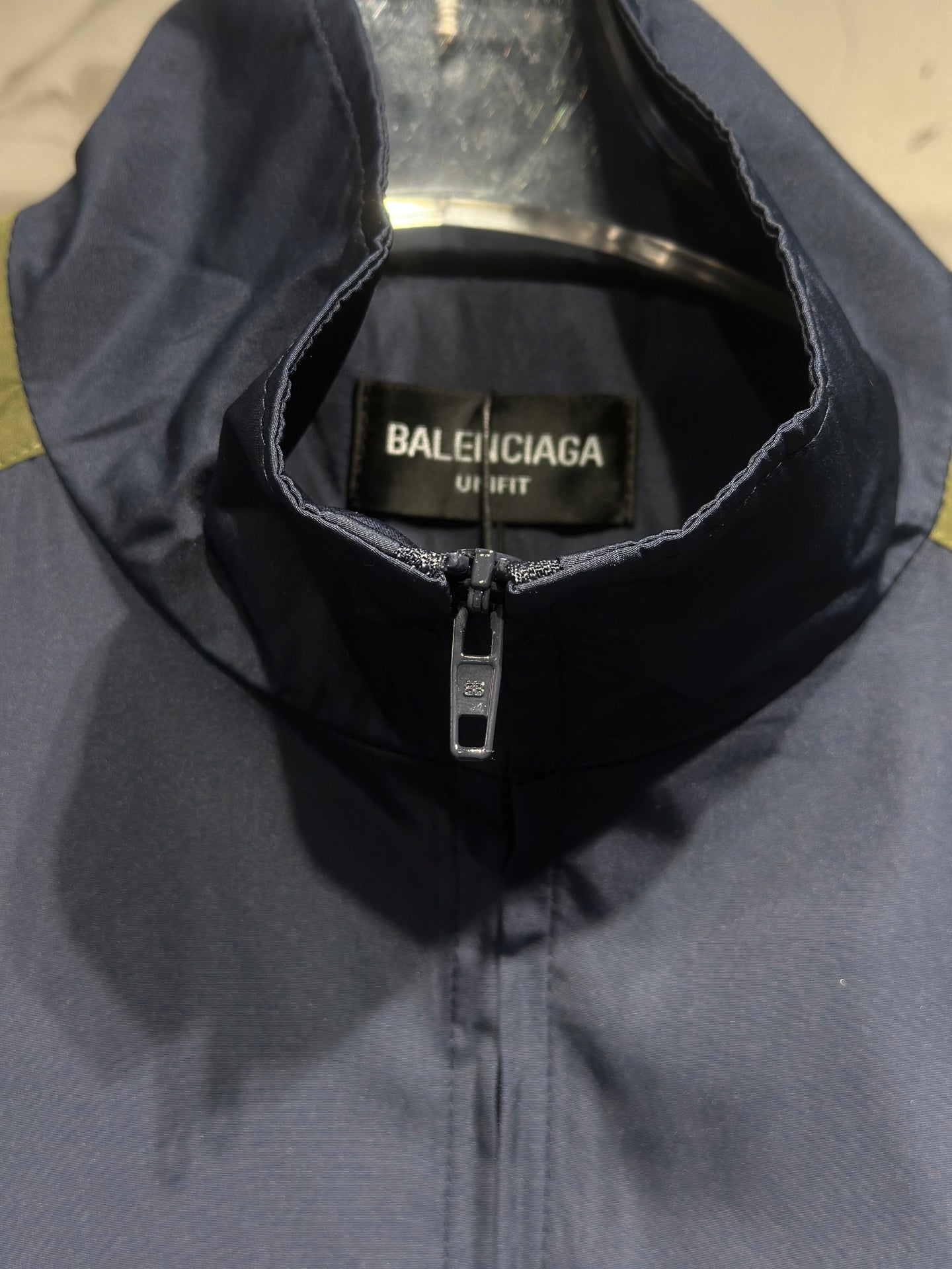 Navy hooded windbreaker with Balenciaga UNIFIT label and front zipper