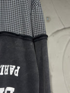 Black hoodie back panel with white graphic partially visible and ribbed hood edge