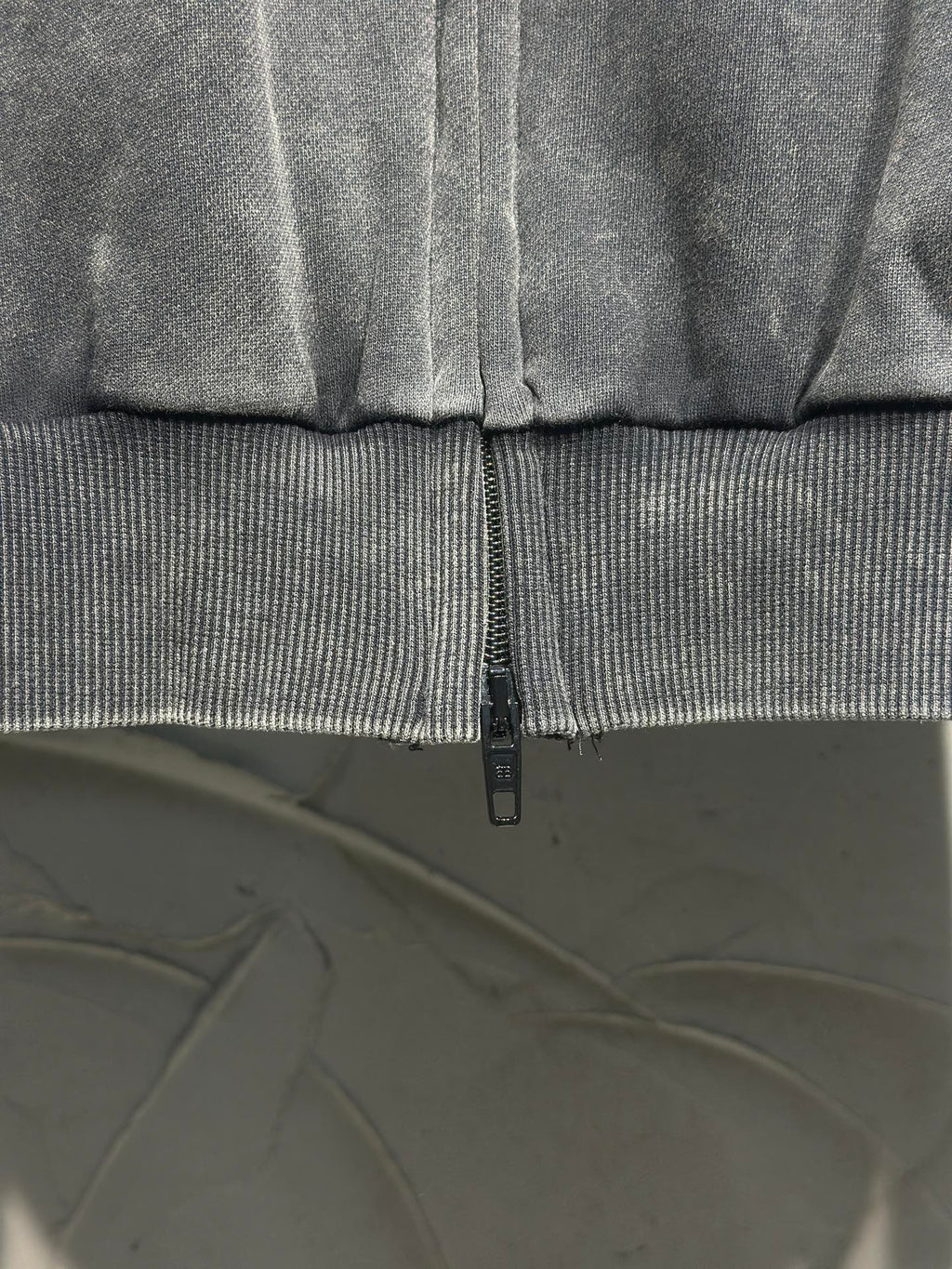 Balenciaga zip-up hooded jacket cuff and central zipper detail, dark gray fabric