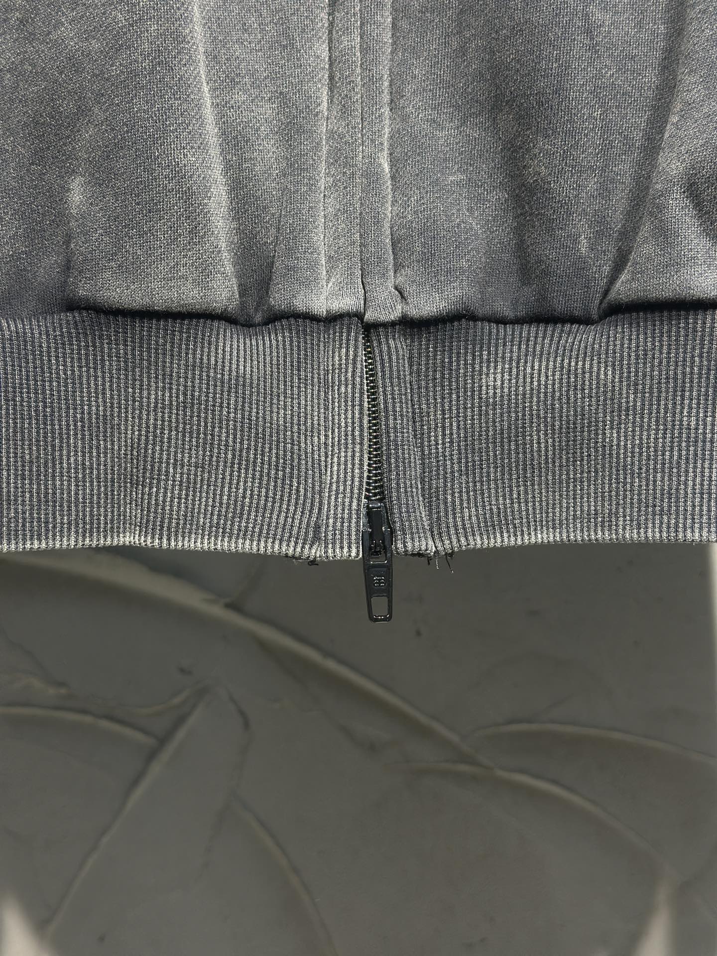 Balenciaga zip-up hooded jacket cuff and central zipper detail, dark gray fabric