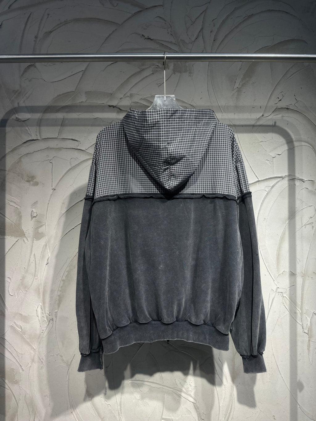 Balenciaga hooded sweatshirt with gray checkered hood and dark body, long sleeves