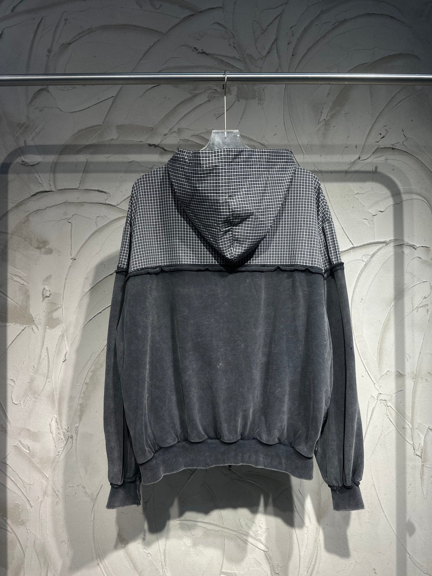 Balenciaga hooded sweatshirt with gray checkered hood and dark body, long sleeves
