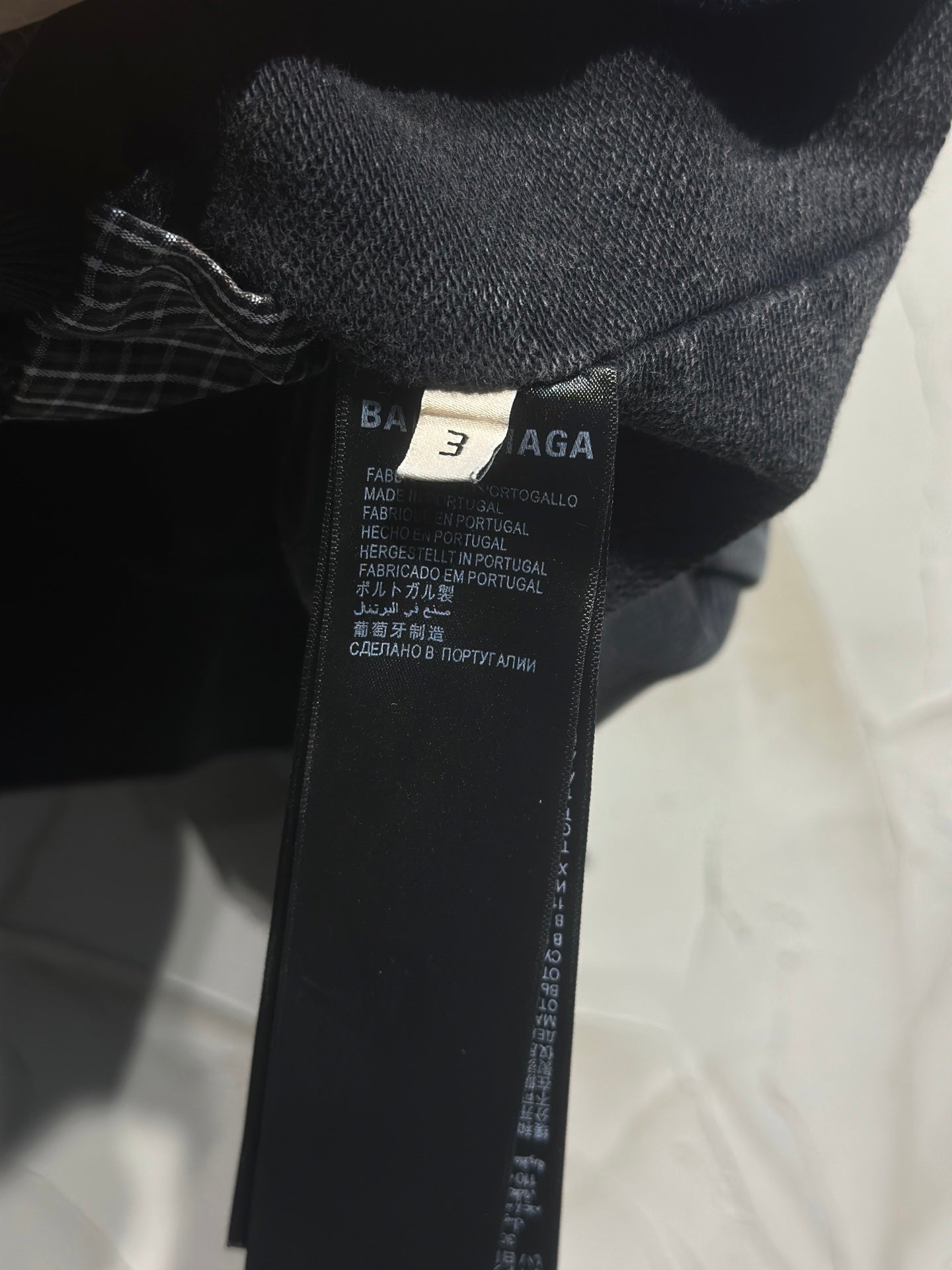 Balenciaga inside neck label on dark hooded jacket